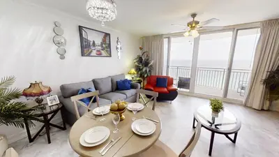 a living room with a couch and a table at Emerald Beach 1835 in Panama City Beach