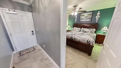 a bedroom with a bed and a white door at Emerald Beach 1835 in Panama City Beach