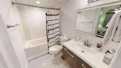 a bathroom with a toilet and a sink and a shower at Emerald Beach 1835 in Panama City Beach