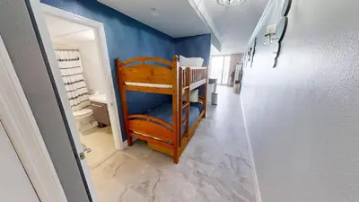 a room with a hallway with a bunk bed in it at Emerald Beach 1835 in Panama City Beach