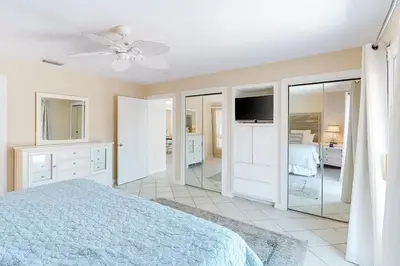 a bedroom with a bed and a television in it at Sandy Shores by Emerald Coast Retreats in Panama City Beach
