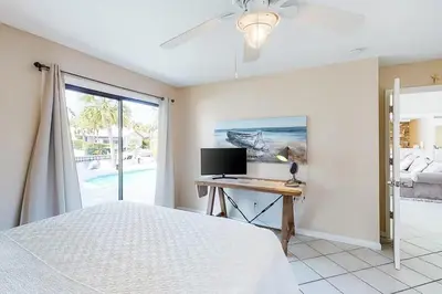 a bedroom with a bed and a desk with a computer at Sandy Shores by Emerald Coast Retreats in Panama City Beach