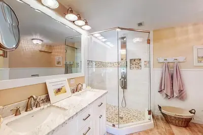 a bathroom with two sinks and a shower at Sandy Shores by Emerald Coast Retreats in Panama City Beach
