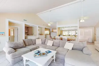 a living room with a couch and a table at Sandy Shores by Emerald Coast Retreats in Panama City Beach