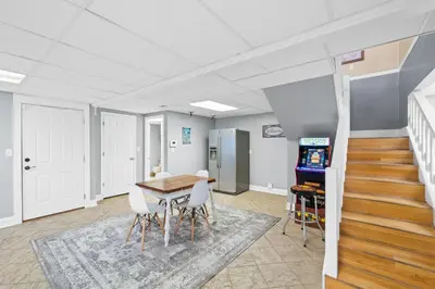 a room with a table and chairs and stairs at Lagoon Cocune by Book That Condo in Panama City Beach