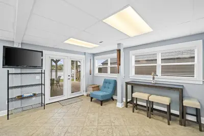 a living room with a desk and a tv at Lagoon Cocune by Book That Condo in Panama City Beach