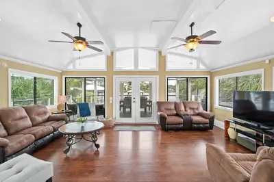 a living room with leather furniture and a flat screen tv at Lagoon Cocune by Book That Condo in Panama City Beach