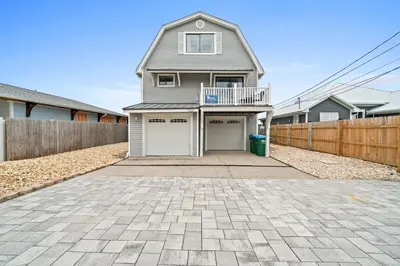 a house with a garage and a fence at Lagoon Cocune by Book That Condo in Panama City Beach
