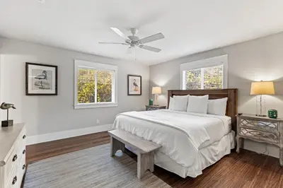 a bedroom with a large bed and two windows at Pool On 30A Gulf Views Balconies Luxury in Inlet Beach
