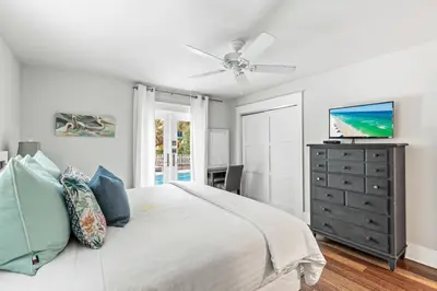 a white bedroom with a bed and a ceiling fan at Pool On 30A Gulf Views Balconies Luxury in Inlet Beach