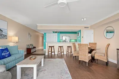 a living room with a couch and a table at Emerald Beach Resort 234 | Roo’s Rendezvous in Panama City Beach