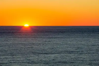 an orange and yellow sunset over the ocean at Watercrest 1110 - Sunset Haven in Panama City Beach