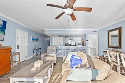 a living room with a couch and a ceiling fan at Emerald Beach Resort 2028 in Panama City Beach