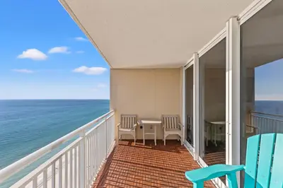a balcony with a table and chairs and the ocean at Emerald Beach Resort 2028 in Panama City Beach