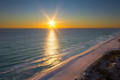 an aerial view of the ocean at sunset at Emerald Beach Resort 2028 in Panama City Beach