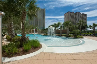 a pool with a fountain in a resort at Emerald Beach Resort 2028 in Panama City Beach