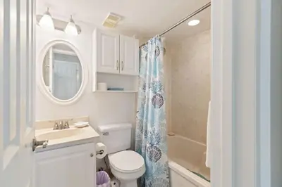 a bathroom with a toilet and a sink and a shower at NEW 30A Beachfront Condo with Pool and 4 Beds with Gulf Views in Santa Rosa Beach