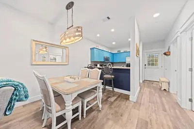 a kitchen and dining room with a table and chairs at Fun Beach Condo on 30A with POOL and Lake and Beach Access in Santa Rosa Beach