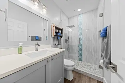 a bathroom with a sink and a toilet and a shower at Fun Beach Condo on 30A with POOL and Lake and Beach Access in Santa Rosa Beach