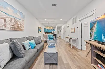 a living room with a couch and a flat screen tv at Fun Beach Condo on 30A with POOL and Lake and Beach Access in Santa Rosa Beach