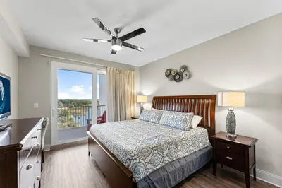 a bedroom with a bed and a large window at Laketown Wharf #0938 in Panama City Beach