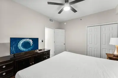 a bedroom with a bed and a flat screen tv at Laketown Wharf #0938 in Panama City Beach