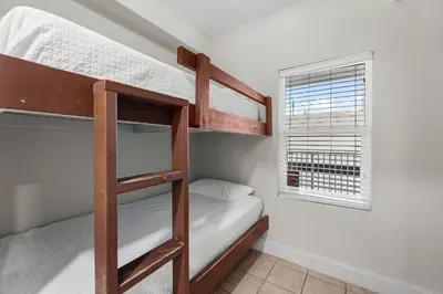 a bunk bed room with two bunk beds and a window at Laketown Wharf #0938 in Panama City Beach