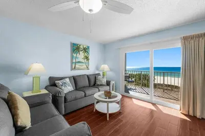 a living room with a couch and a view of the ocean at The Summit 408 in Panama City Beach