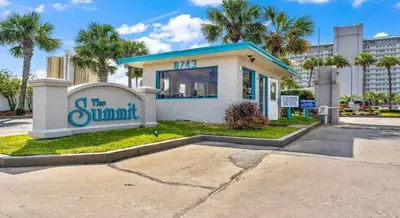 a building with a sign that reads the summit at The Summit 408 in Panama City Beach