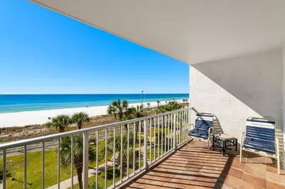 a balcony with two chairs and the beach at The Summit 408 in Panama City Beach