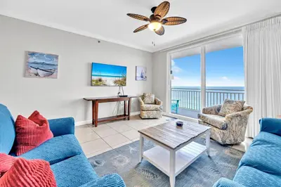 a living room with blue couches and a table at Splash 1803W in Panama City Beach