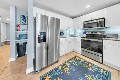 a kitchen with a stainless steel refrigerator and appliances at Grand Panama 1-1807 in Panama City Beach