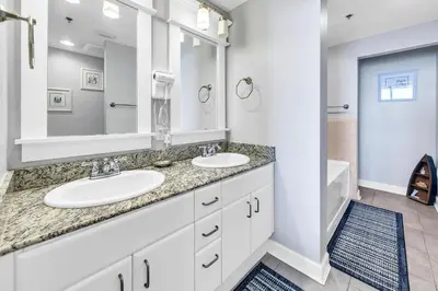 a bathroom with two sinks and a large mirror at Grand Panama 1-1807 in Panama City Beach