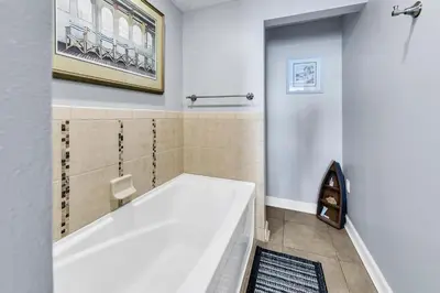 a bathroom with a large tub and a shower at Grand Panama 1-1807 in Panama City Beach