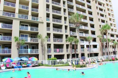 a swimming pool in front of a large apartment building at Grand Panama 1-1807 in Panama City Beach