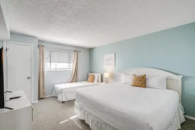 a bedroom with two beds and a window at Regency Towers PCB Condo Beach Access and 2 Pools in Panama City Beach