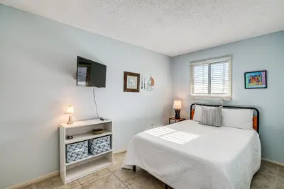 a bedroom with a bed and a tv in it at Regency Towers PCB Condo Beach Access and 2 Pools in Panama City Beach