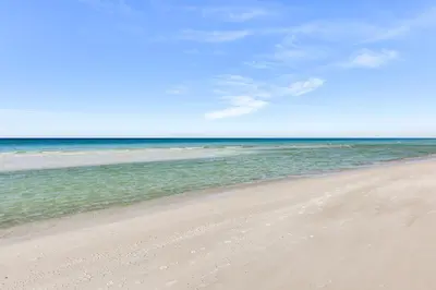 a sandy beach with the ocean in the background at Regency Towers PCB Condo Beach Access and 2 Pools in Panama City Beach