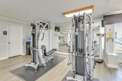 a gym with treadmills and exercise bikes at Regency Towers PCB Condo Beach Access and 2 Pools in Panama City Beach