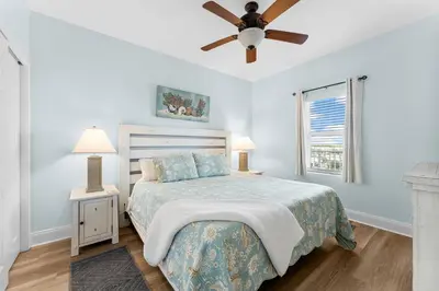 a bedroom with a bed and a ceiling fan at Laketown Wharf #624 Beautiful Gulf View by Nautical Properties in Panama City Beach