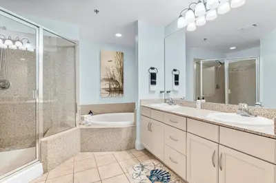 a bathroom with two sinks and a tub and a shower at Laketown Wharf #624 Beautiful Gulf View by Nautical Properties in Panama City Beach