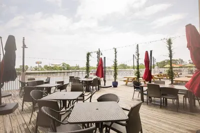 a patio with tables and chairs on a deck at Laketown Wharf #624 Beautiful Gulf View by Nautical Properties in Panama City Beach