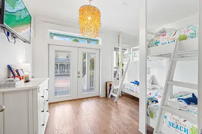 a bedroom with two bunk beds and a desk at Mi CaSEAta in Rosemary Beach