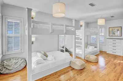 a white room with bunk beds in it at Surf on Turf -Whole House in Rosemary Beach
