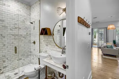 a white bathroom with a sink and a toilet at Surf on Turf -Whole House in Rosemary Beach