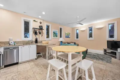 a kitchen with a table and chairs in a room at Grand Tortuga Squirt in Panama City Beach