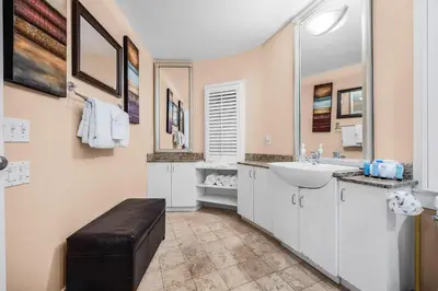a white bathroom with a sink and a toilet at Grand Tortuga Squirt in Panama City Beach