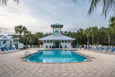 a swimming pool with a clock tower in the background at Grand Tortuga Squirt in Panama City Beach