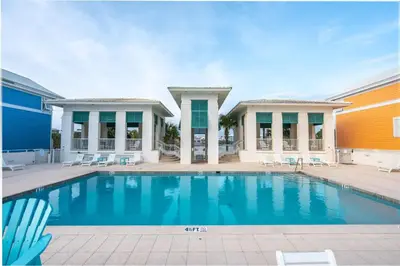 a swimming pool in front of a building at Grand Tortuga Squirt in Panama City Beach