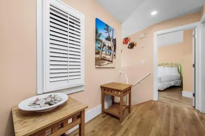 a room with a table and a window and a bed at Grand Tortuga Squirt in Panama City Beach